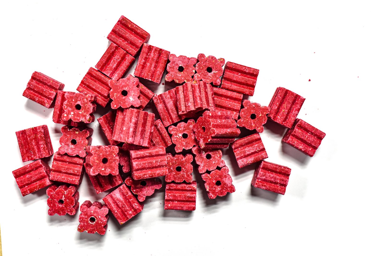 A pile of rat poison tablets, containing toxic rodenticide.